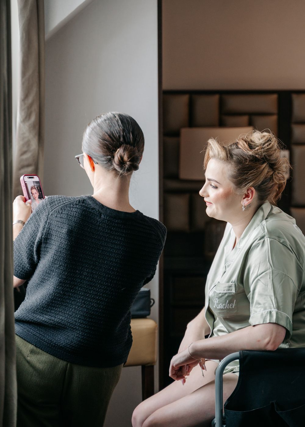 Wedding party members in casual attire getting ready in a hotel room.