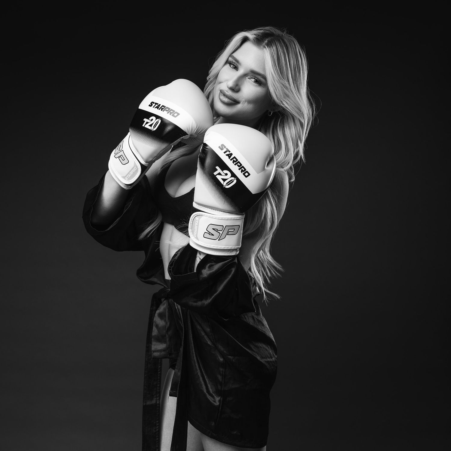 A black and white portrait series of a boxer posing with white gloves against a dark background.