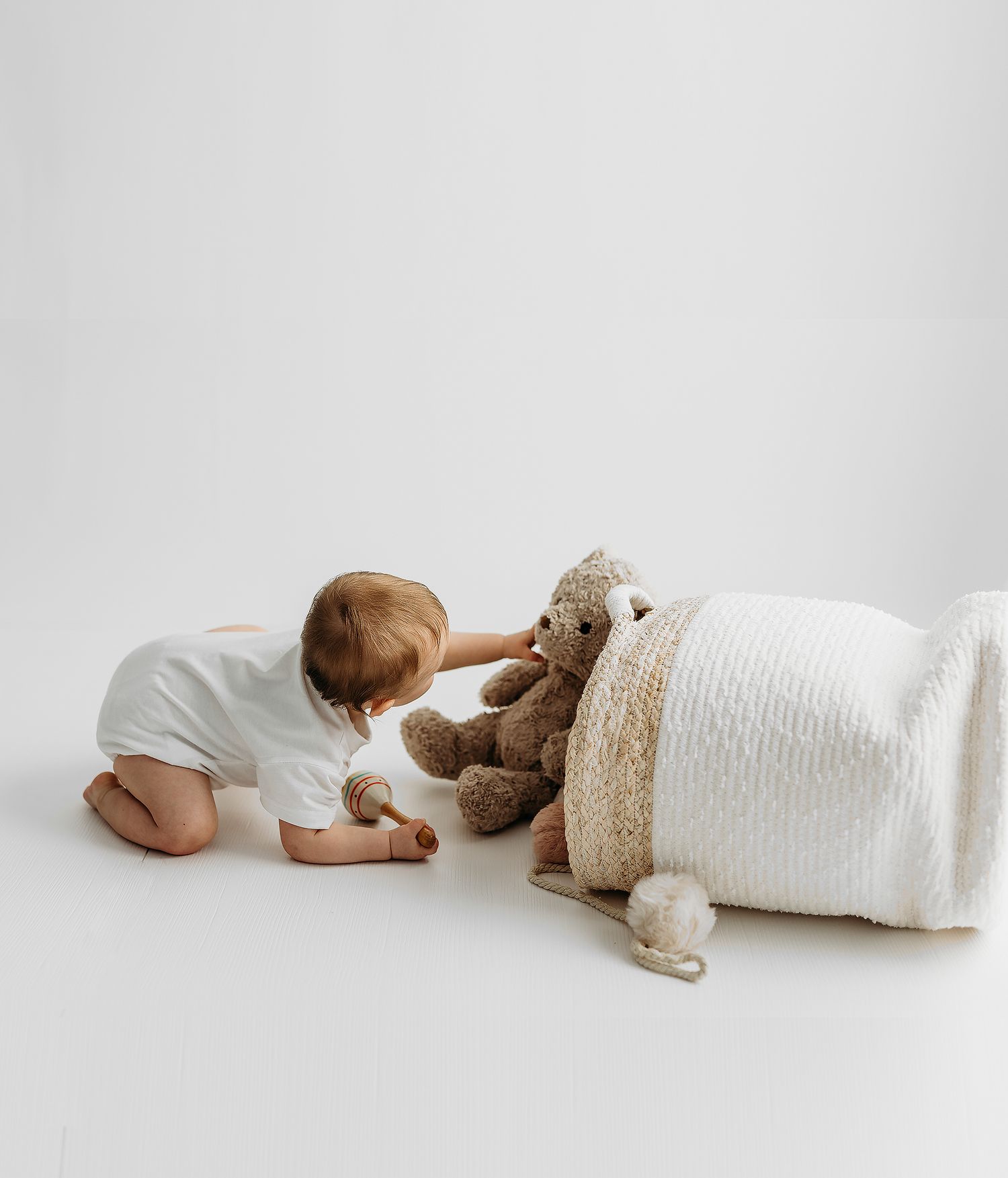 Four heartwarming connected shots of a baby in a striped romper on a white backdrop, displaying crawling progress and expressions.