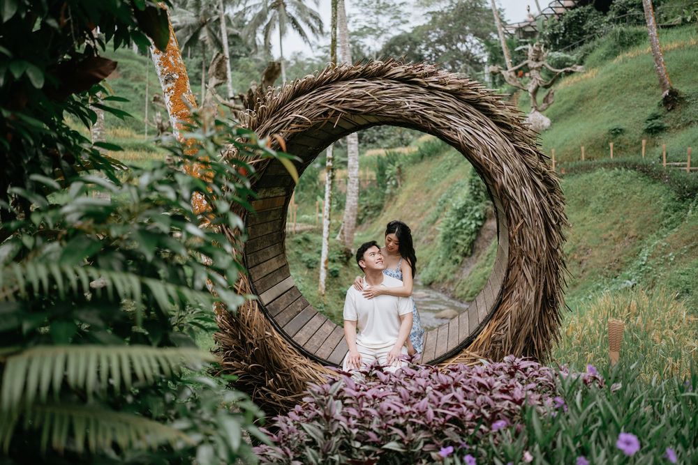 A dreamy portrait in a large woven nest structure surrounded by tropical gardens.