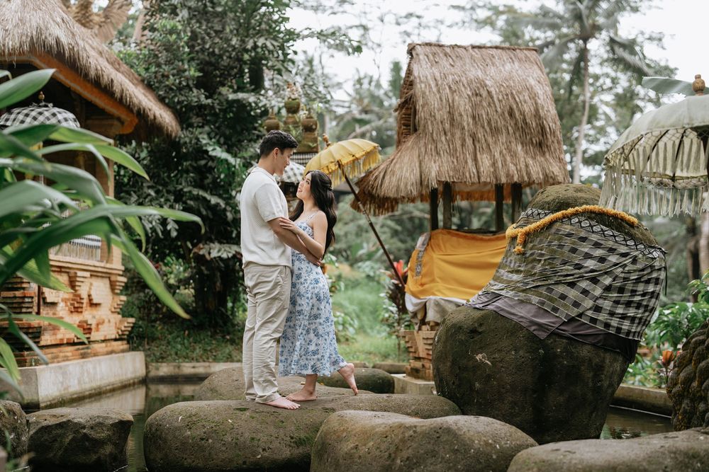 Traditional thatched-roof huts nestled among tropical foliage create a peaceful scene.