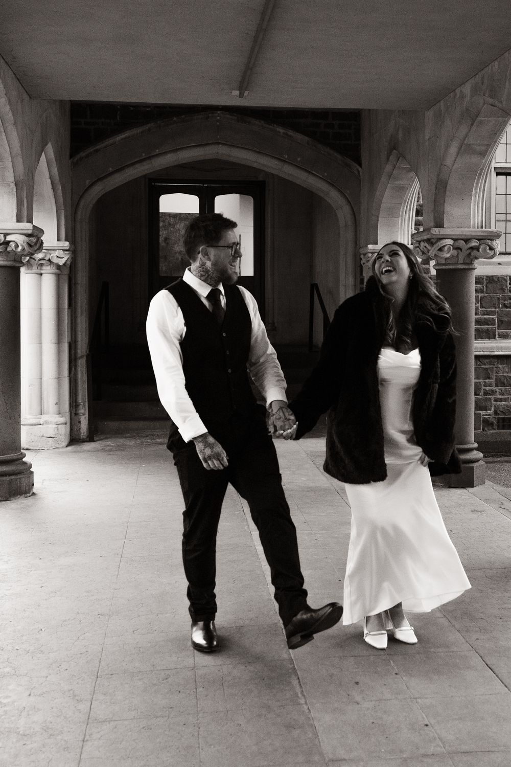 newly married couple walking and laughing after elopement ceremony