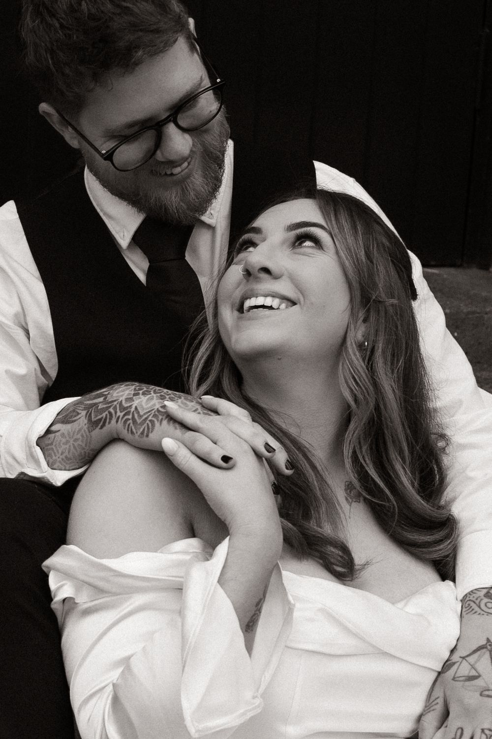 bride looking up at husband and smiling during elopement session in christchurch