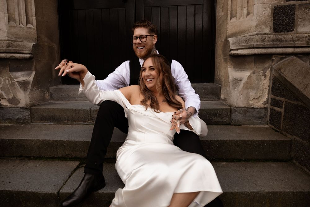 husband and wife laughing during elopement session in Christchurch