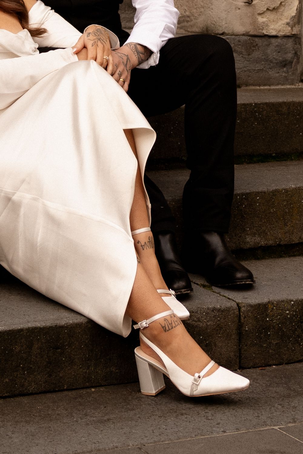 couple holding hands on steps in christchurch