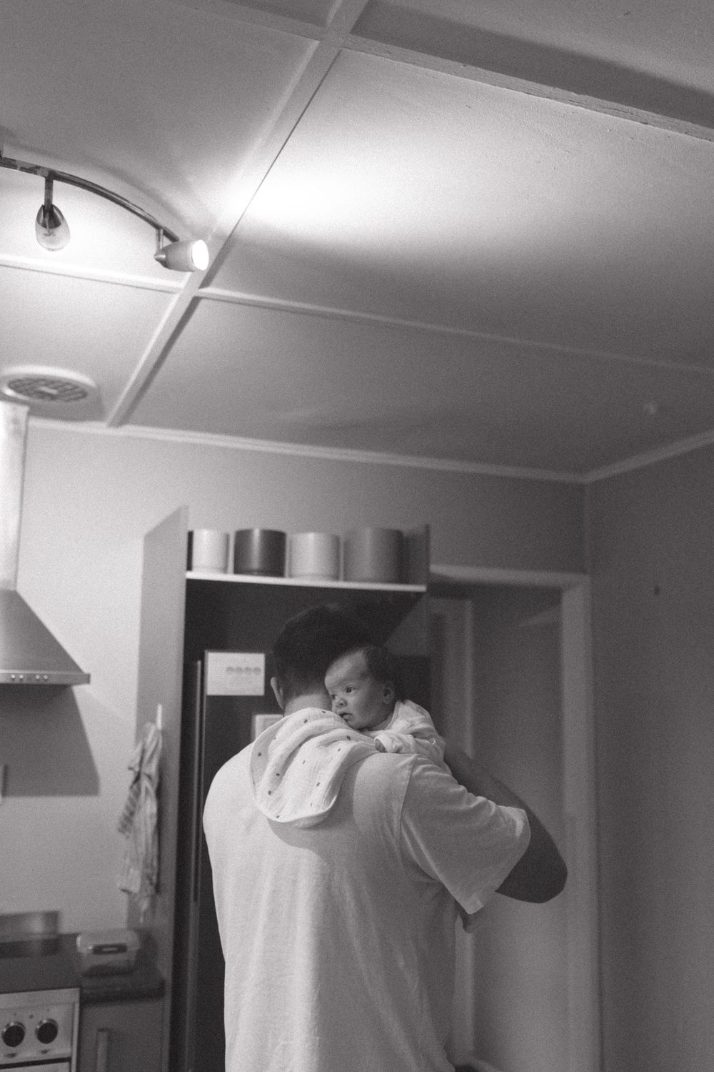 Black and white images showing movement across an interior room with white walls and ceiling.