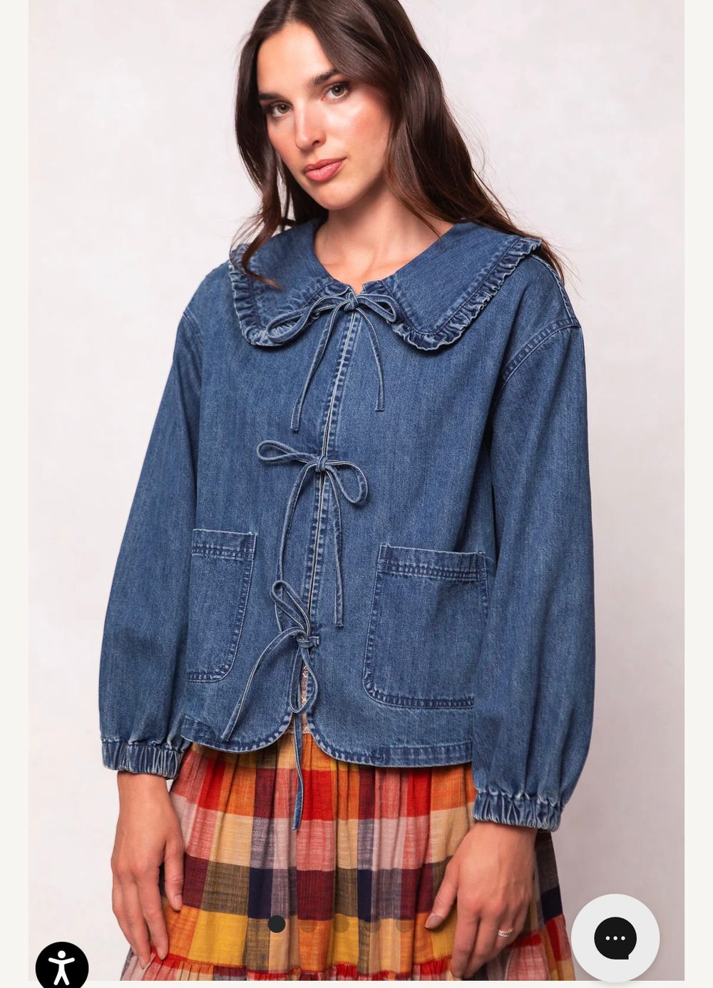 A cropped denim jacket with puff sleeves and plaid pleated skirt creates a stylish contrast in casual fashion.