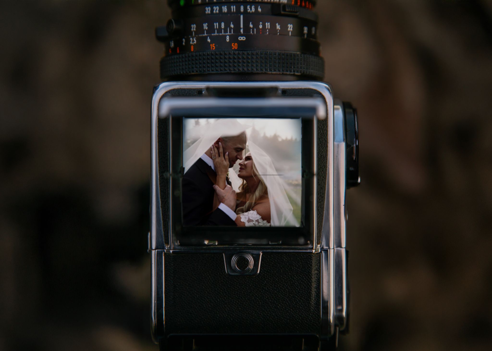 Medium format film camera with a wedding couple reflected in the viewfinder, Tkshotz digital and film wedding photography