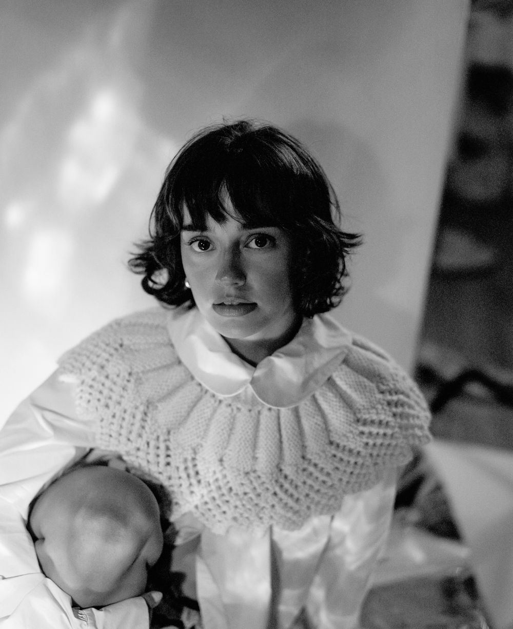 Black and white portrait with dramatic collar detail and soft lighting.