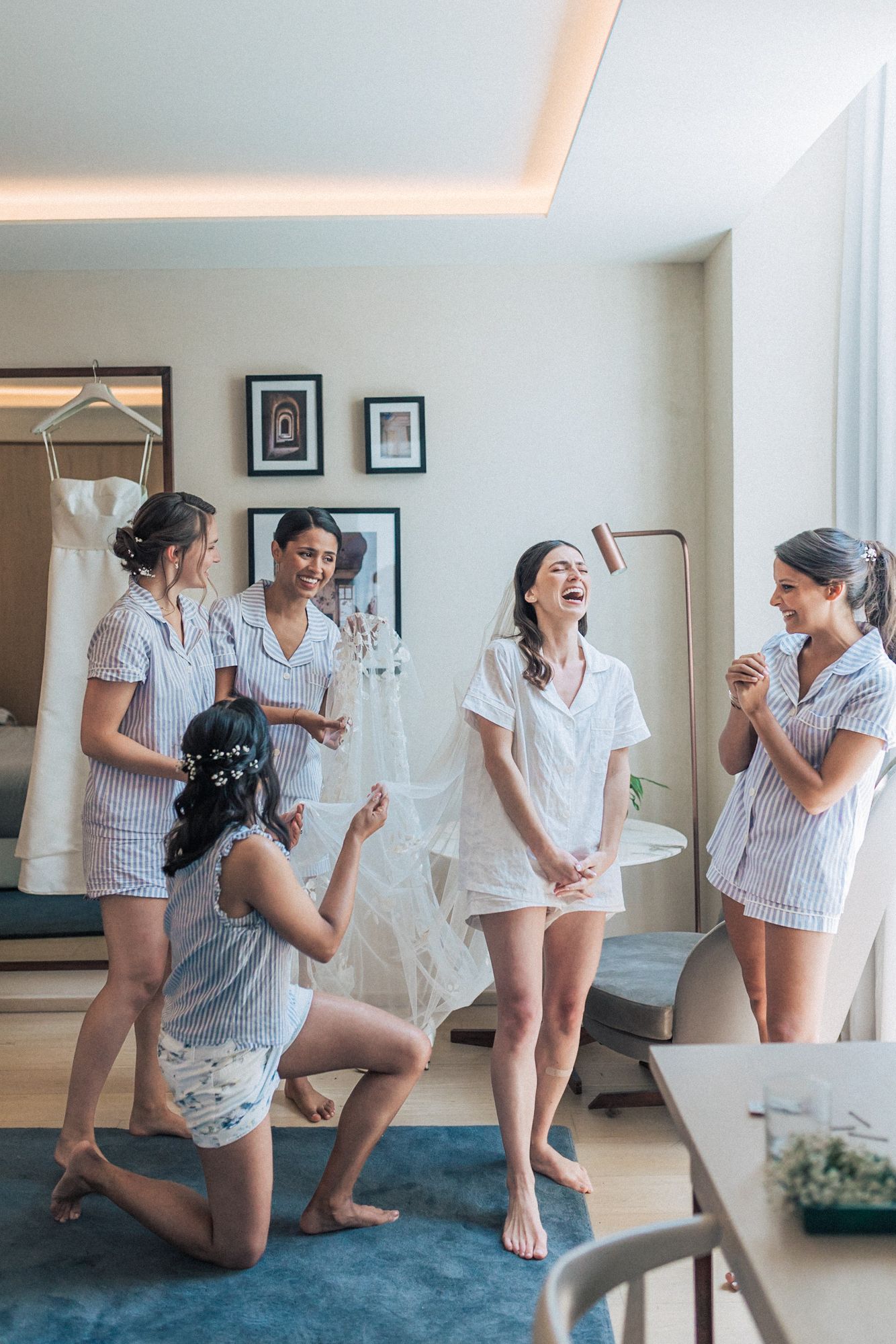 Wedding preparations with bridesmaids in pajamas celebrating. captured by a Lisbon wedding photographer at the one, palacio da anunciada