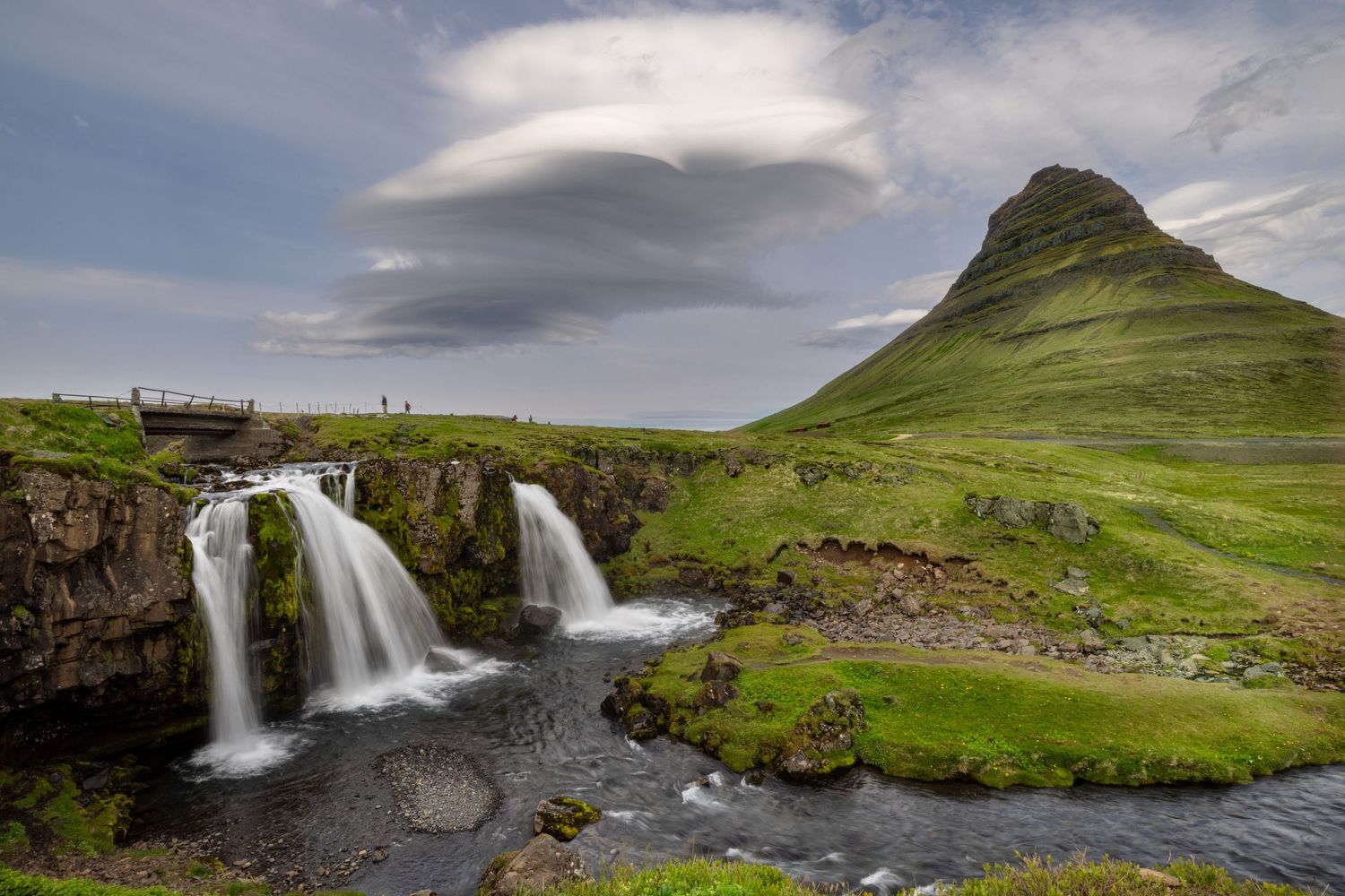swirling cloud formations over kirkjufell waterfall in Iceland