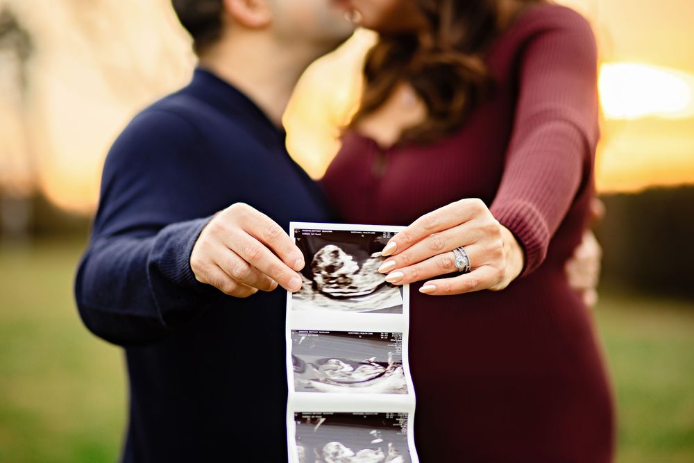 A sequence of hands holding ultrasound photos in various outdoor settings with warm lighting and natural backgrounds.