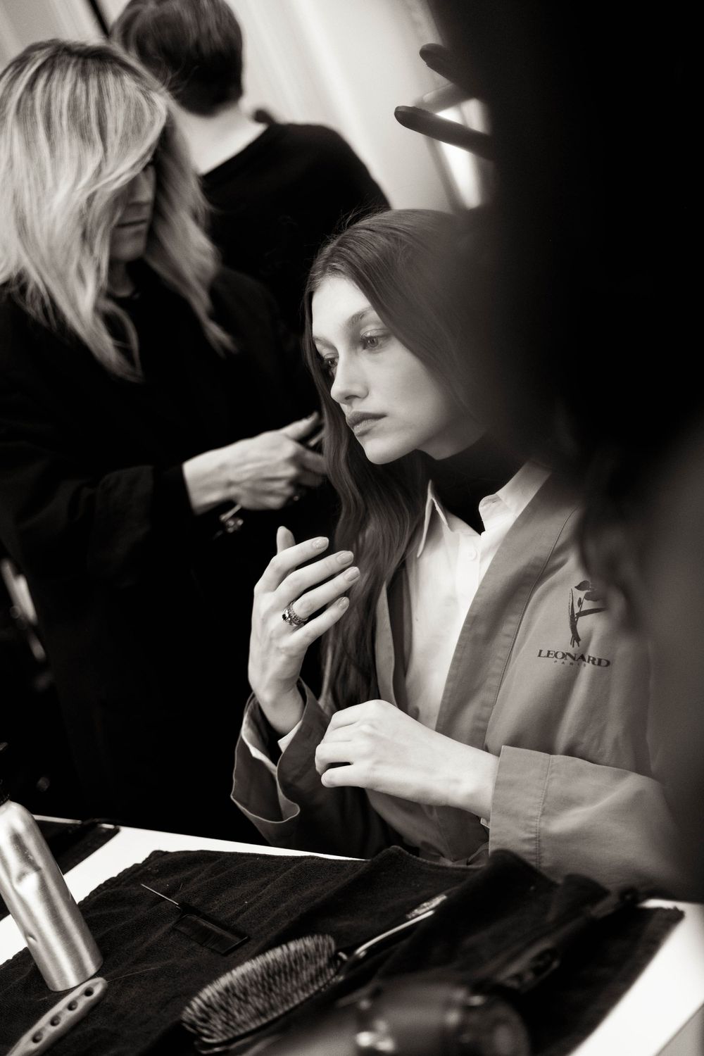 Behind the scenes preparation moment in a dressing room with styling tools.
