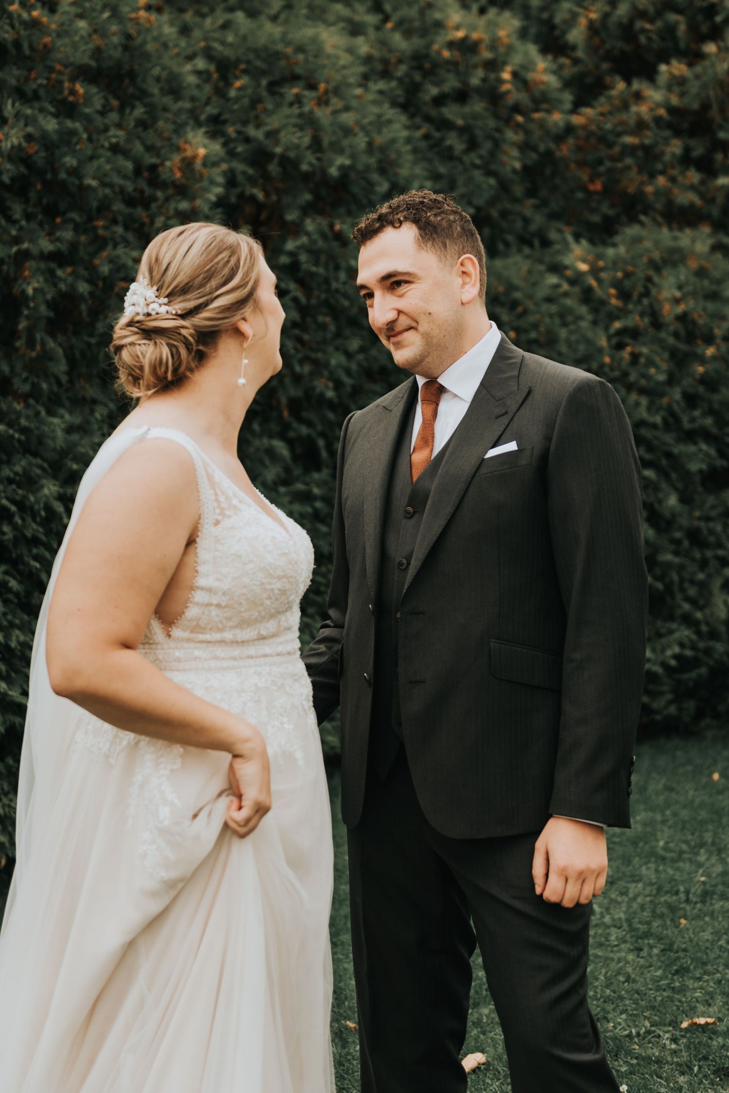 Joyful couple share first look moment on their wedding day during outdoor garden ceremony.