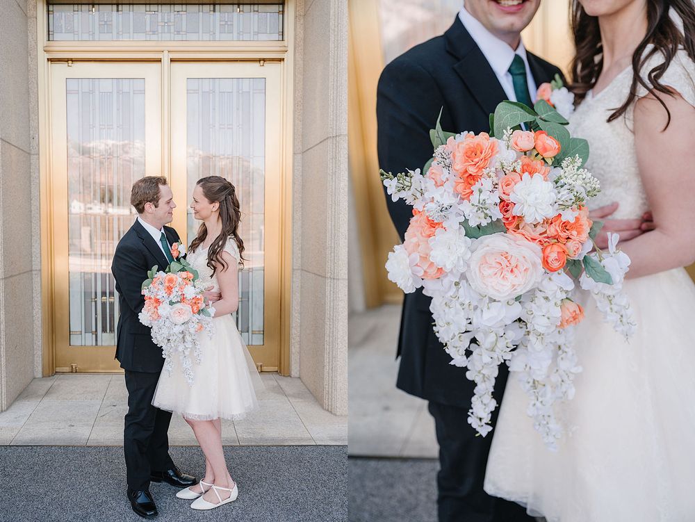 Wedding couple poses romantically in an elegant doorway with a peach and white floral bouquet.