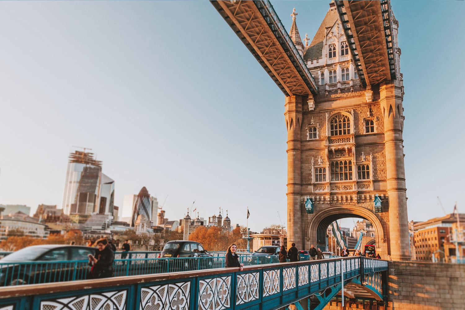 Tower Bridge in London with modern city skyline visible through iconic architectural frame.