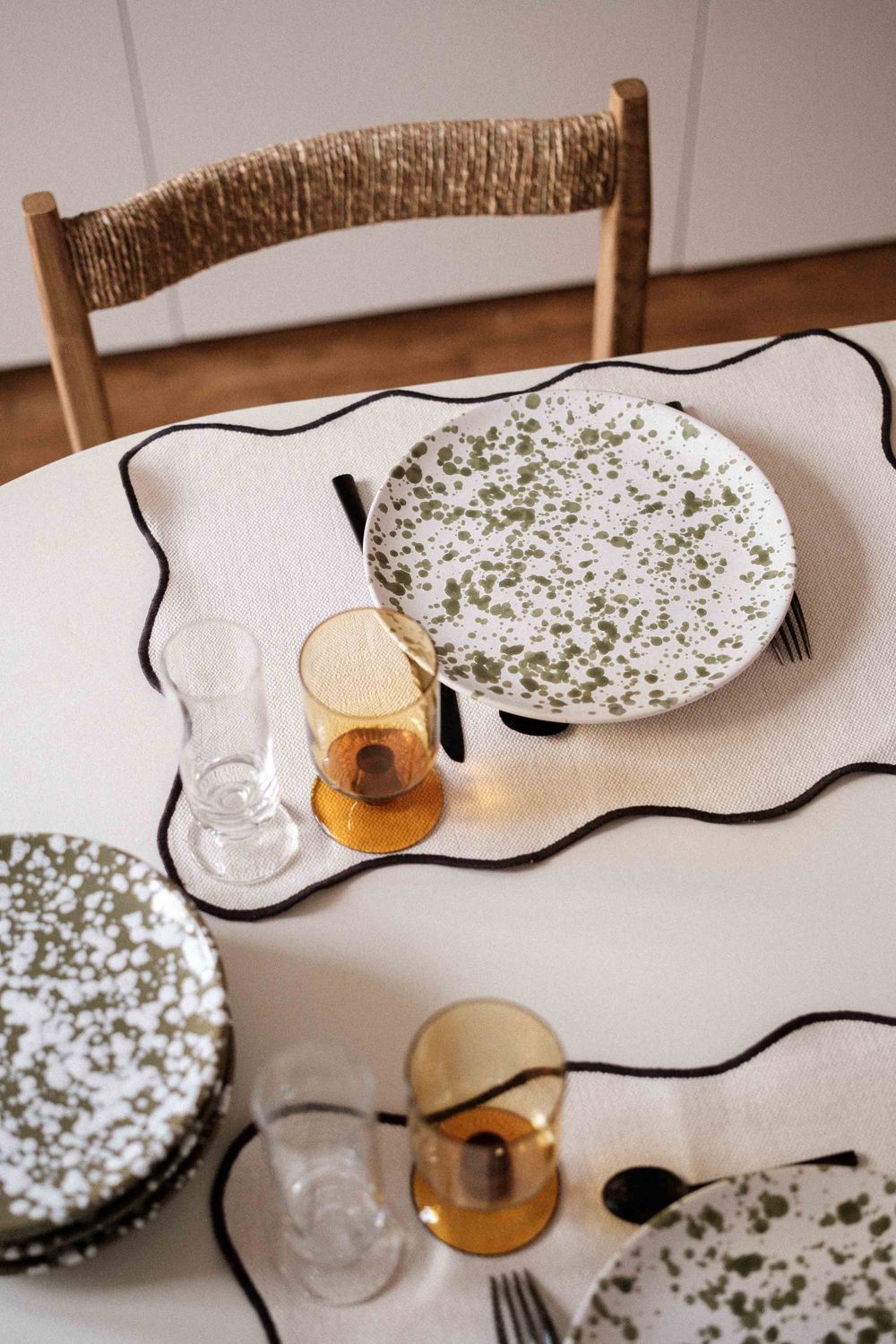 Overhead view of dining table with floral patterned plates and amber glassware.