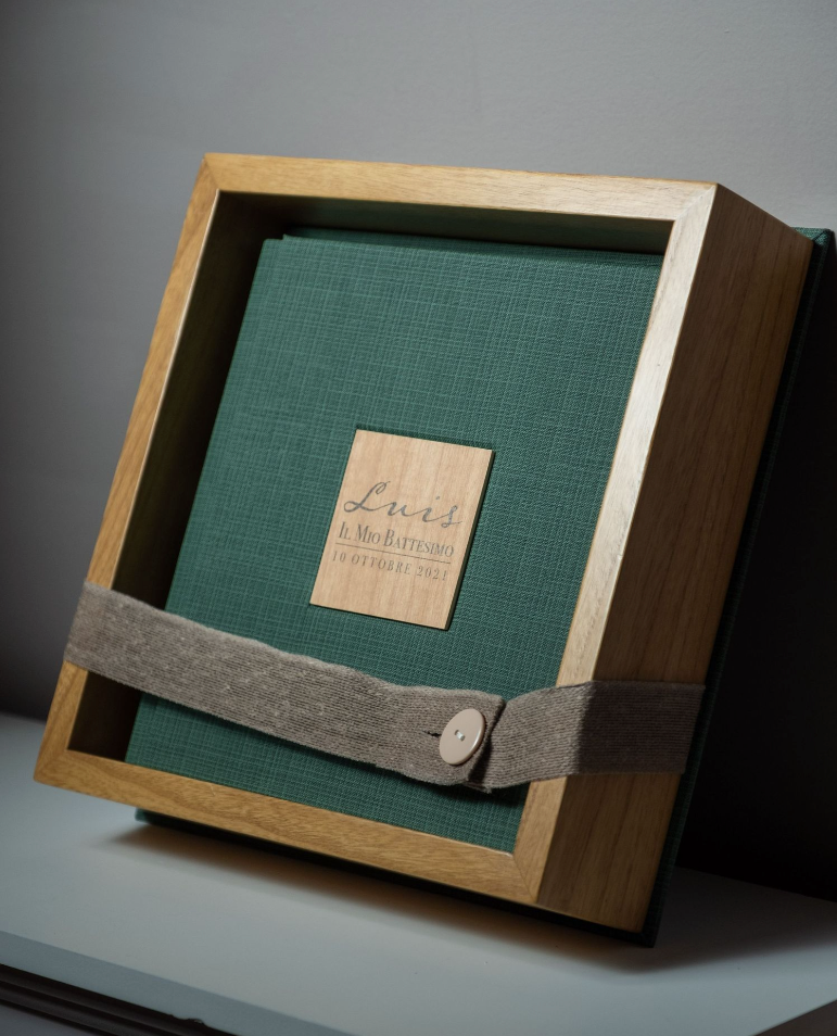 Wooden photo box with green fabric interior and metal closure.