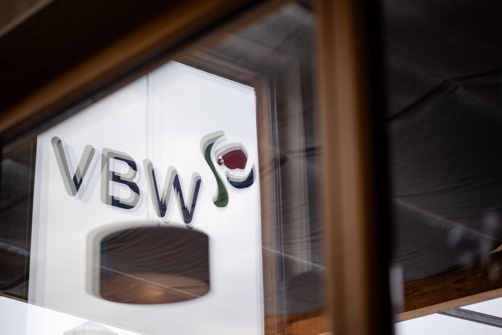 Close-up view of a white VBW sign mounted on a window.