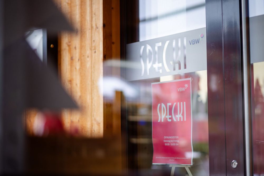 Blurred view of a backlit cafe sign with wooden details.