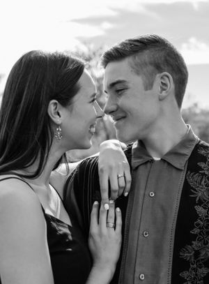 A romantic black and white photo sequence shows a couple sharing tender kisses and intimate moments outdoors.