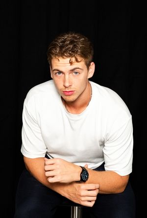 A series of black and white portraits showing someone in a white t-shirt posing against a dark background.