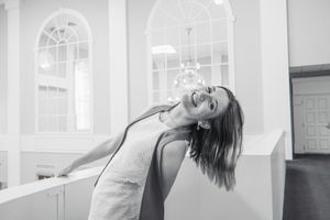Black and white photo sequence showing dynamic dance-like poses in a bright interior space.