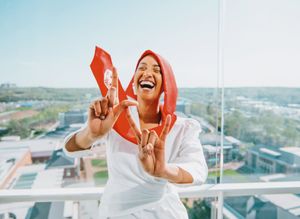 Energetic photo sequence showing joyful expressions in white attire against a city backdrop.