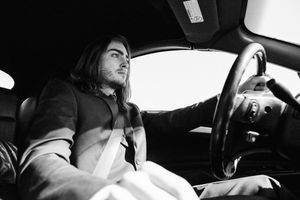 Black and white photo sequence showing a person driving a car at night through multiple frames.