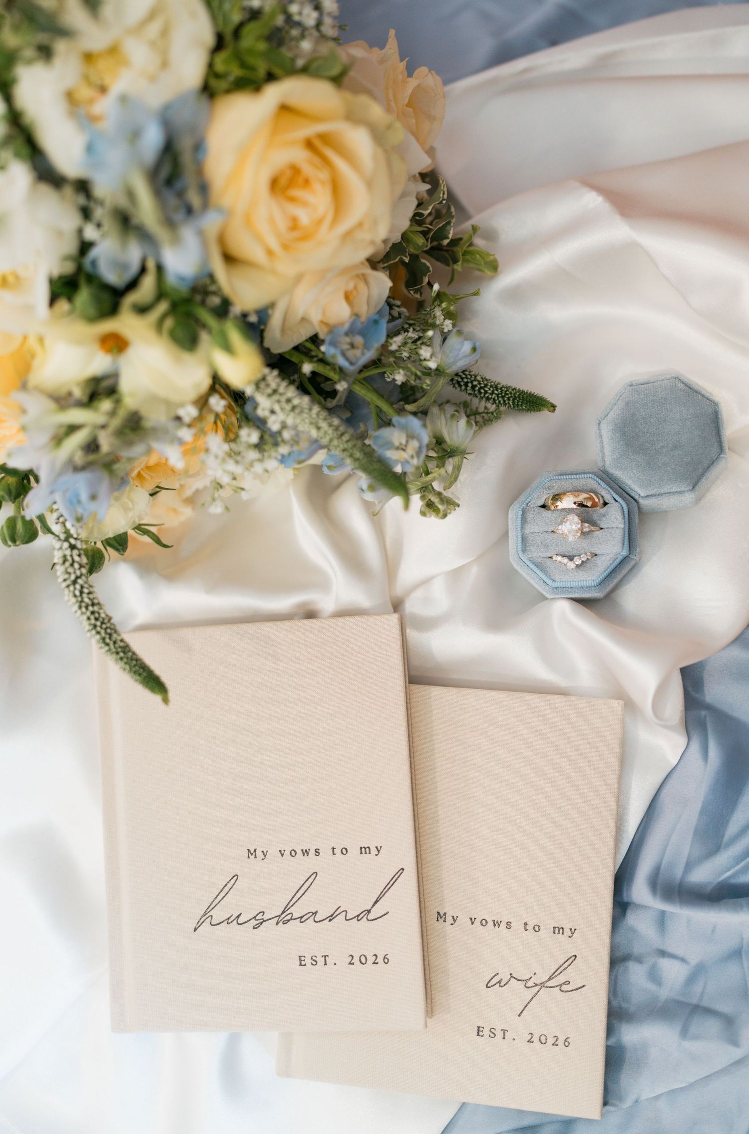 Wedding detail shot with Jack Daniels bottle, cake crumbs, and polaroid photo on wooden surface.
