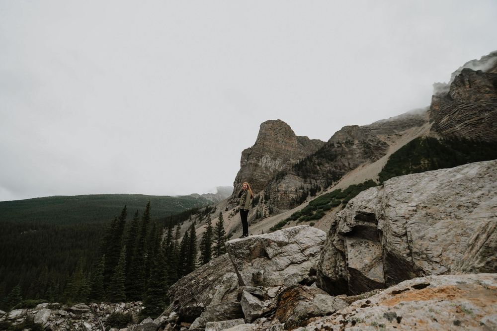Dramatic rocky mountain landscape with rugged cliffs against overcast sky.
