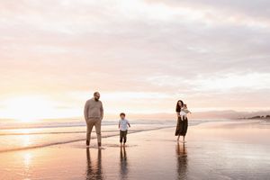 Family enjoying the sunrise at the beach, Christchurch