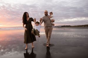 dad holding daughter and mum and dad throwing son in the air during family session at Christchurch