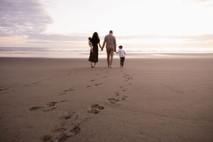 family walking towards the beach during family session, christchurch