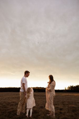 Family maternity session at McLeans island, family looking at plane flying over and pointing