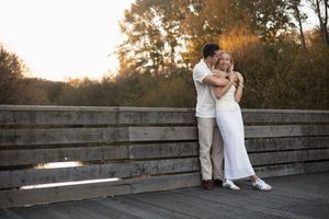 couple standing on the bridge and cuddling during sunset session, the groynes Christchurch