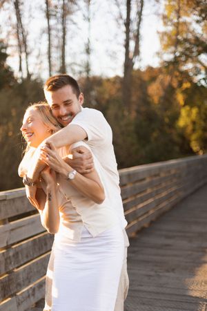 Couple laughing and cuddling during session at sunset at The Groynes, Christchurch