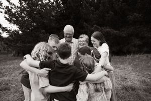 grandkids cuddling in to grandparents during extended family session at Bottle lake forest
