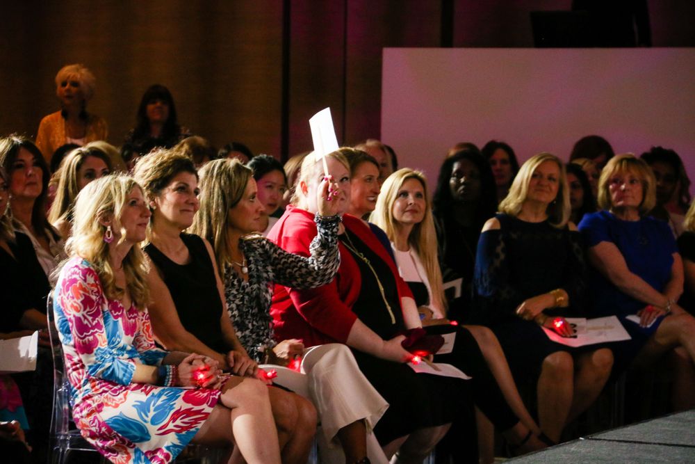 Wedding guests seated in rows watching an emotional ceremony.