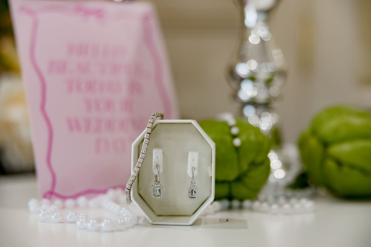 An elegant octagonal pendant with delicate details displayed on a white surface with decorative elements.