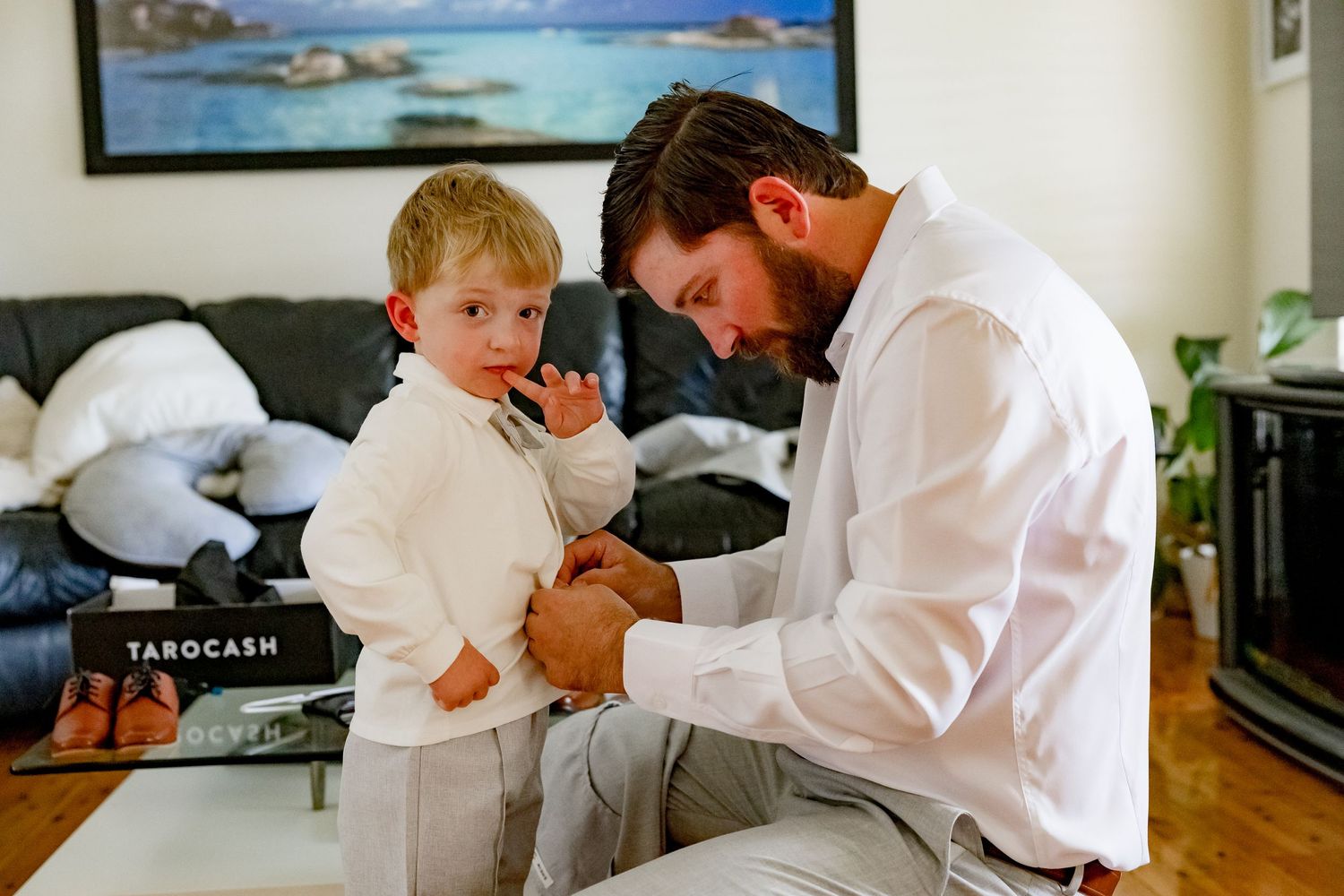 A touching moment of preparation as formal attire is adjusted.