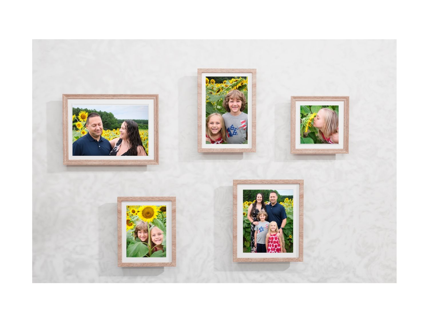 Five framed photos displayed on a white textured wall showcase outdoor portrait photographs with sunflowers and natural settings.