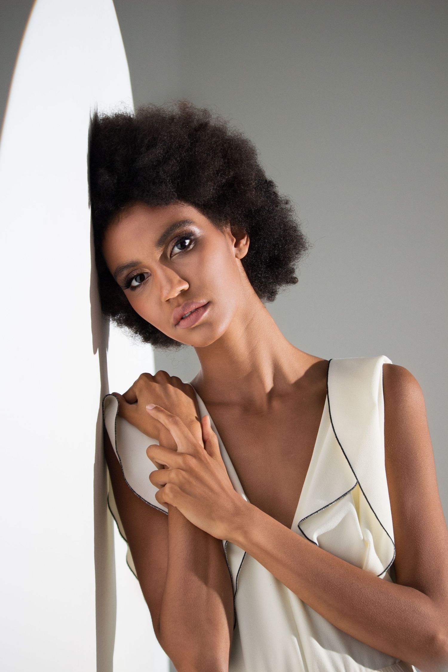 Zurich-based fashion studio photoshoot featuring elegant white outfit and soft shadows. Professional beauty photography. Best