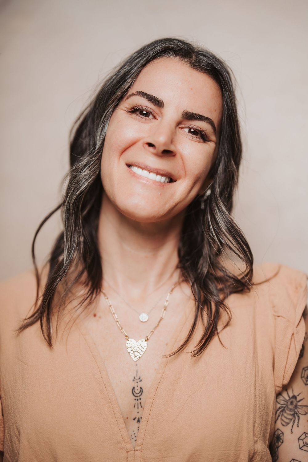 A series of five portraits showing a person in a beige top with layered necklaces and dark hair against a neutral background.