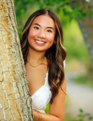 Natural light portrait session featuring soft bokeh effect and birch trees in the background.