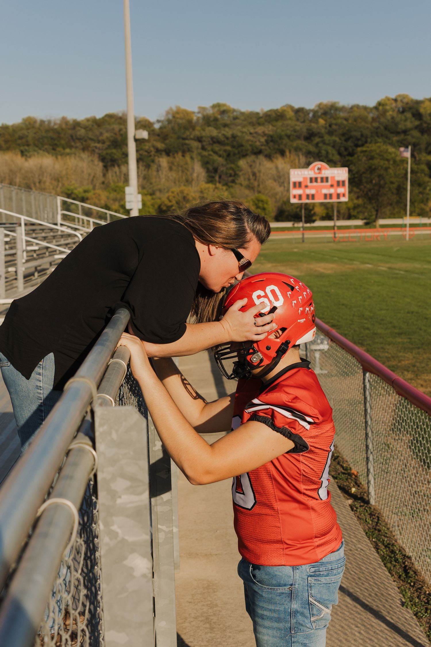A sequence of photos showing a person in jeans and black top interacting with someone in a red sports jersey by a fence.