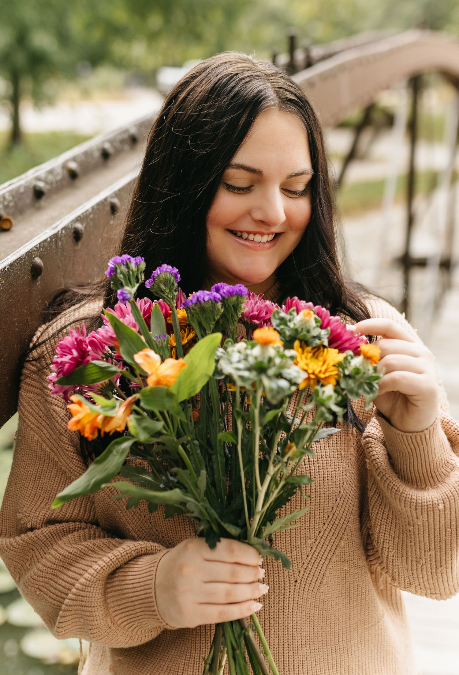 A series of photos showing someone holding a colorful bouquet of fresh flowers while wearing a brown sweater.
