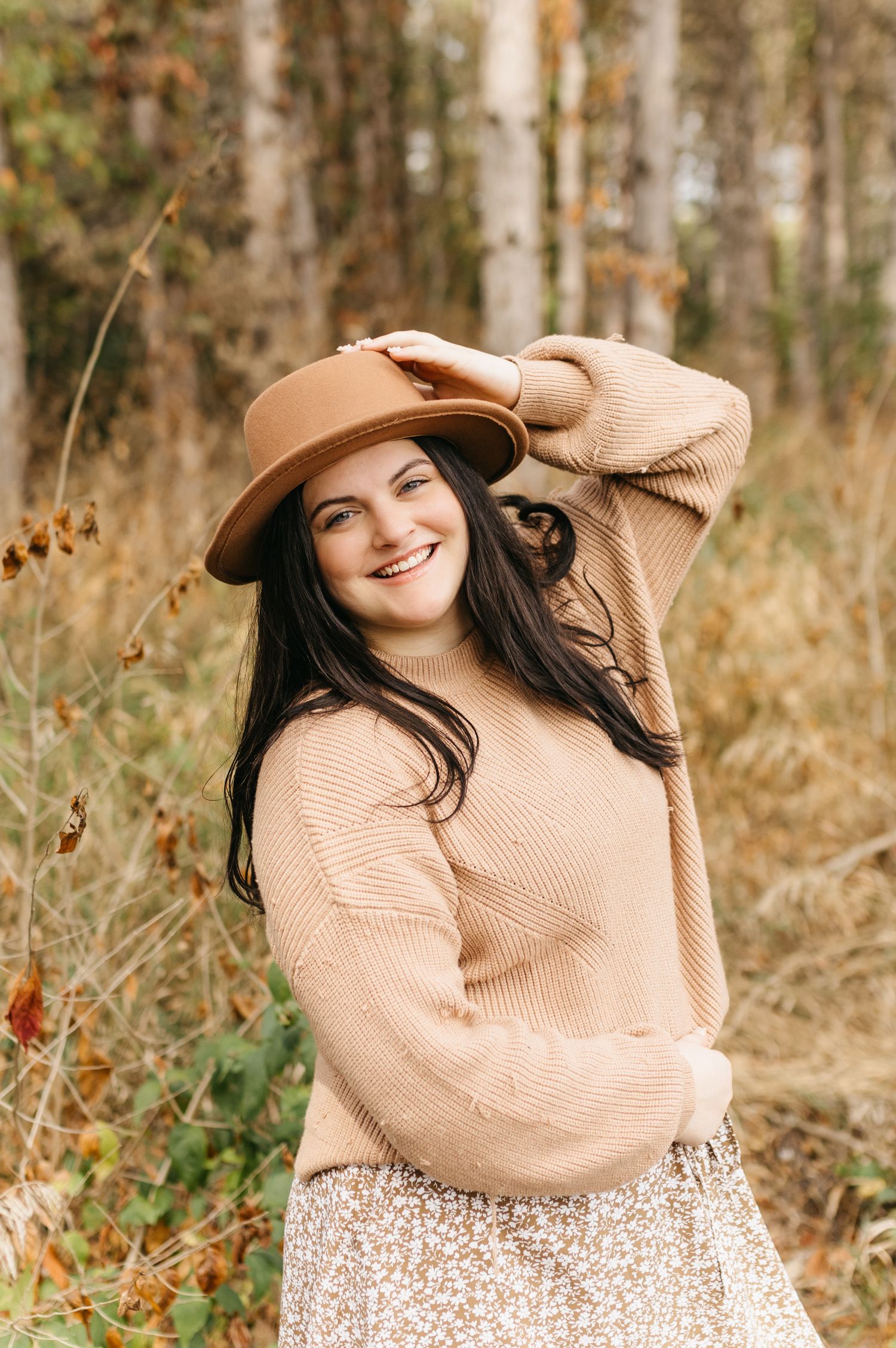 A cozy autumn portrait series in a beige sweater against a natural woodland background.