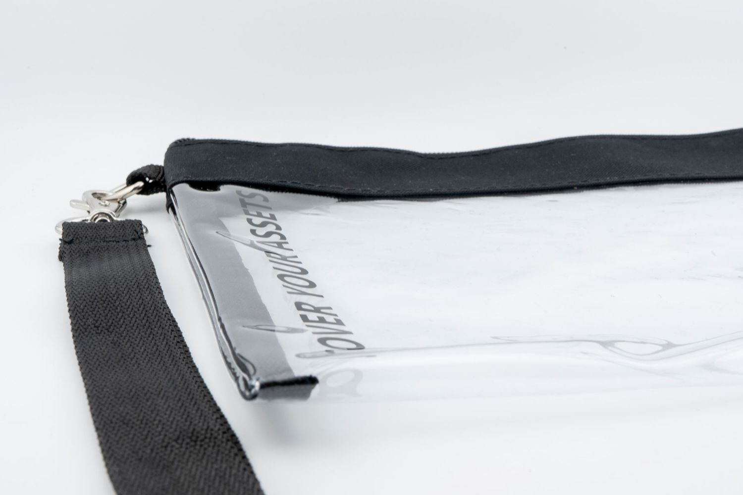A close-up view of a black lanyard strap with a clear ID badge holder attached.