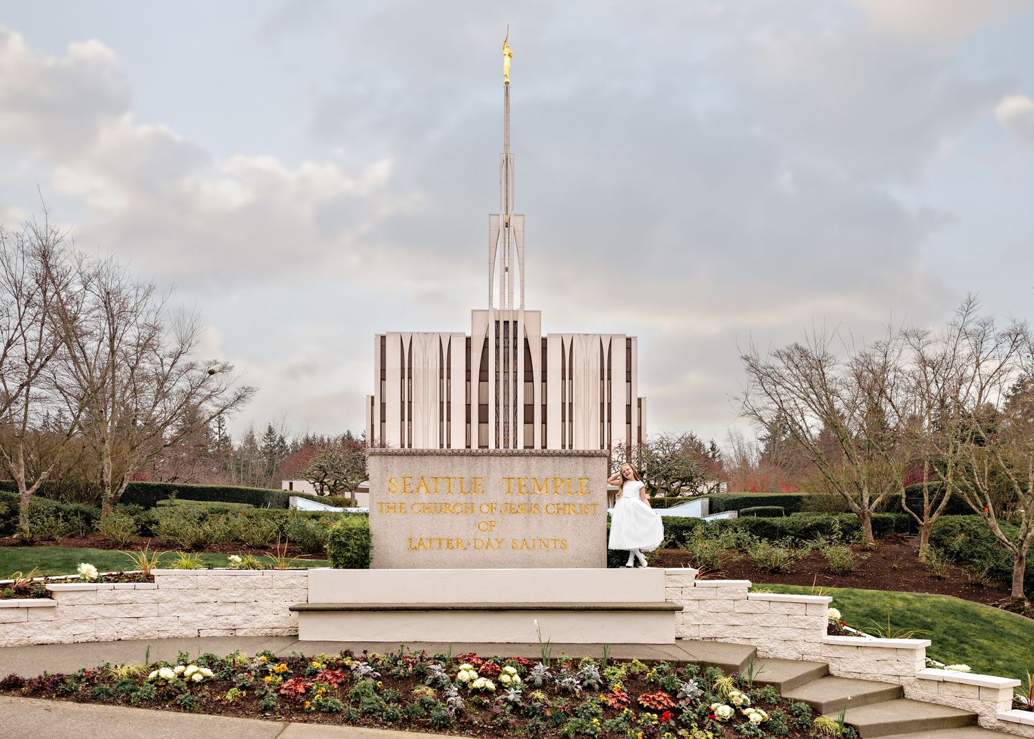 A panoramic view of the Seattle Washington Temple with its white spires and surrounding gardens in spring.